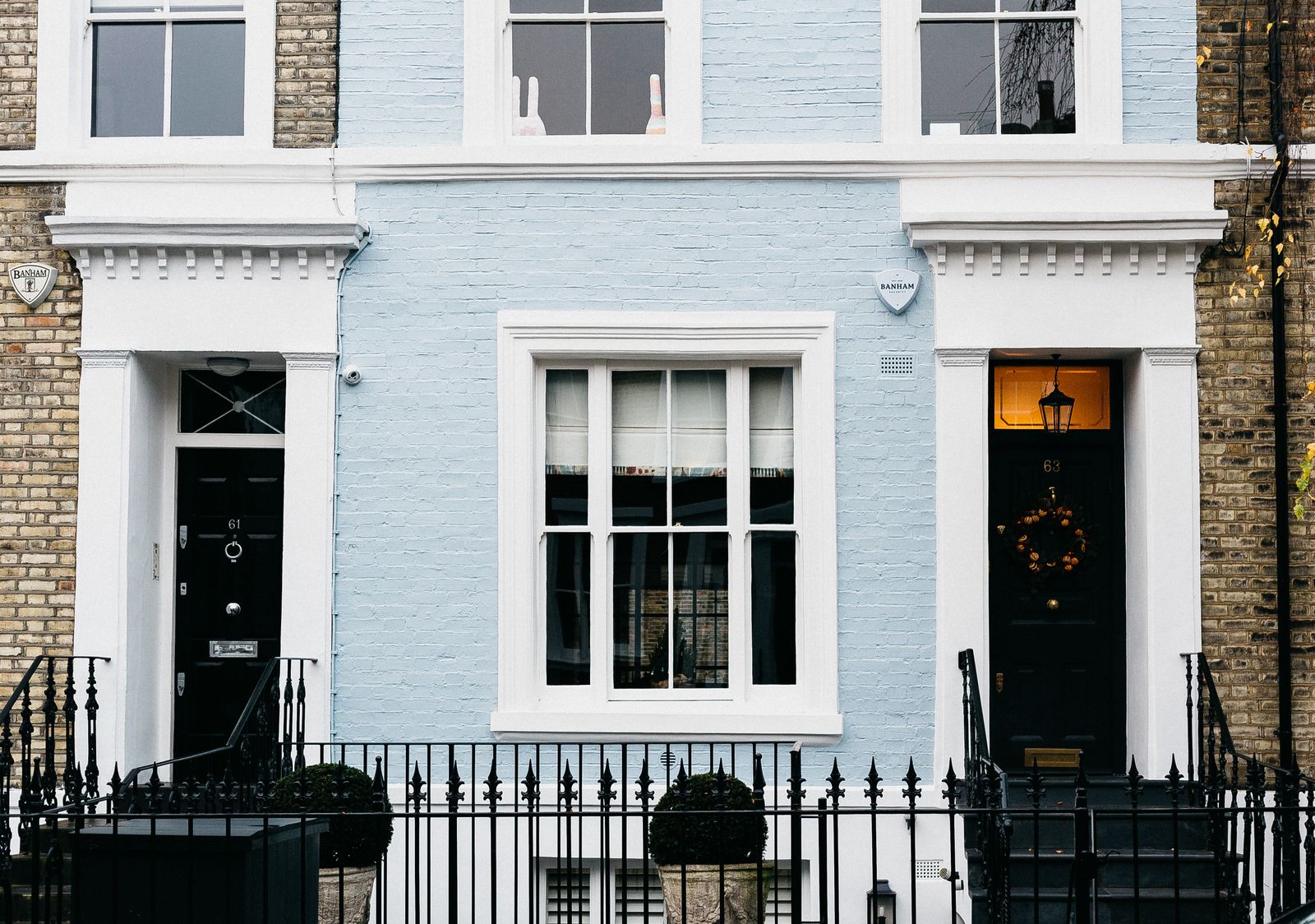 Georgian townhouse facade with black railings and doors in London